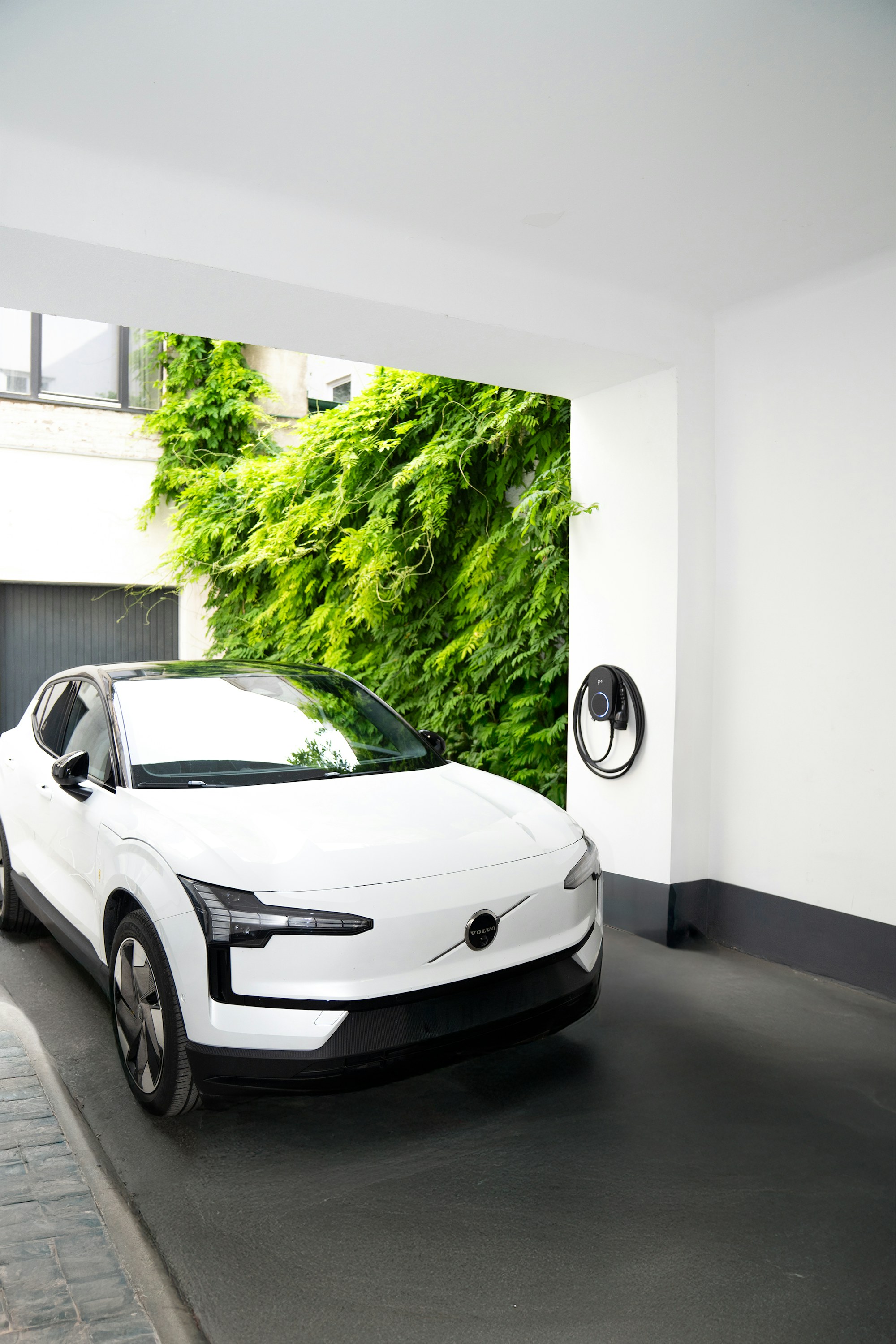 Modern EV charge point installed beside a parked car